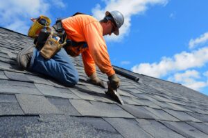 A photo of a roofer from Manitoba roofers working on a roof of a house in Winnipeg, in a sunny day, blue sky in the background